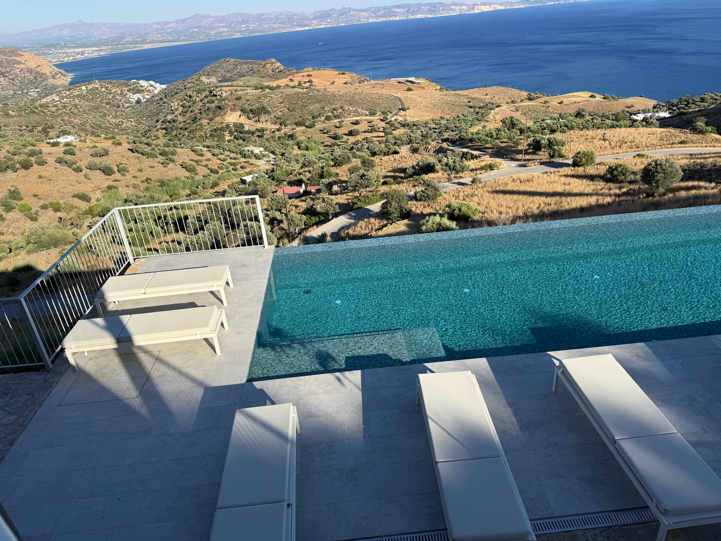 Panorama over the infinity pool, hills and the Libyan Sea coastline