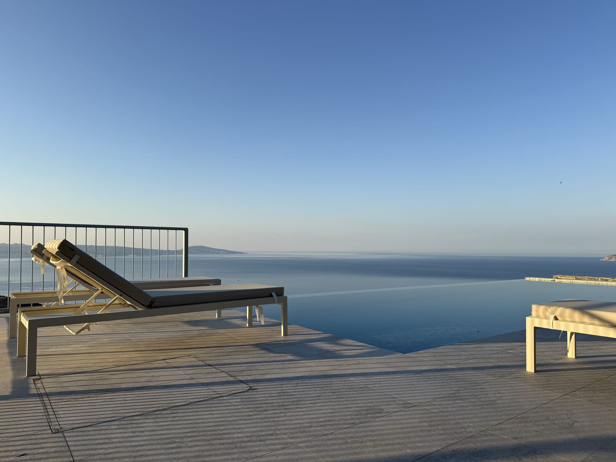 Sunbeds at the infinity-pool edge above the Libyan Sea