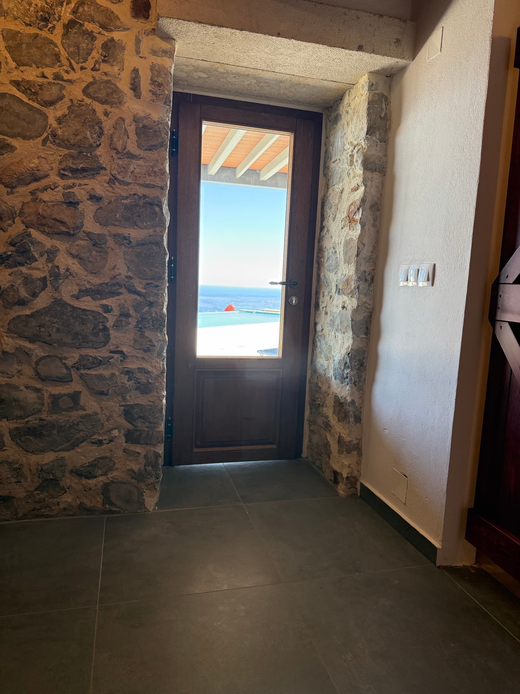 Sea view through the Jasmine suite doorway to the pool terrace