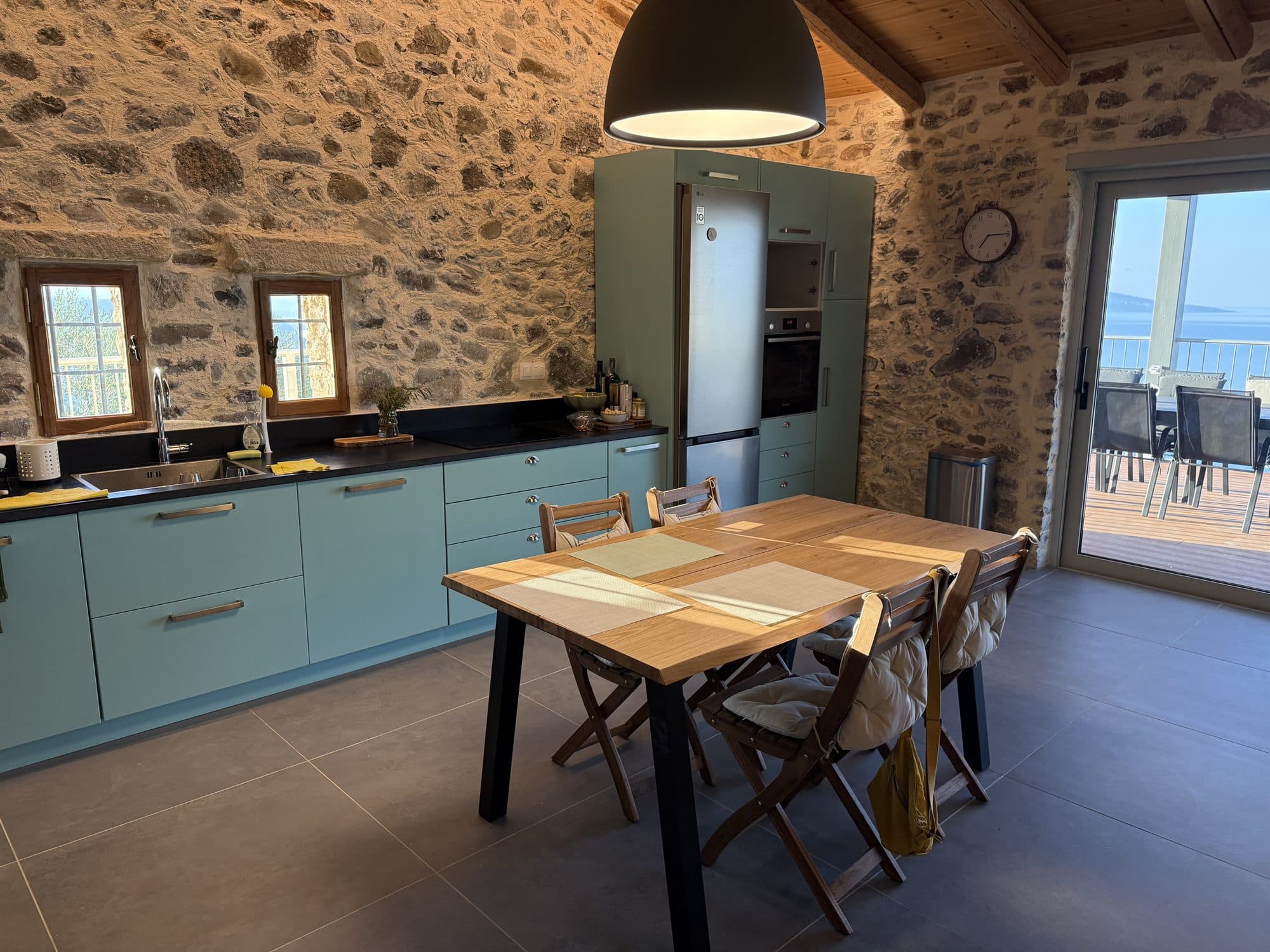Kitchen and oak dining table with the Libyan Sea through the doors