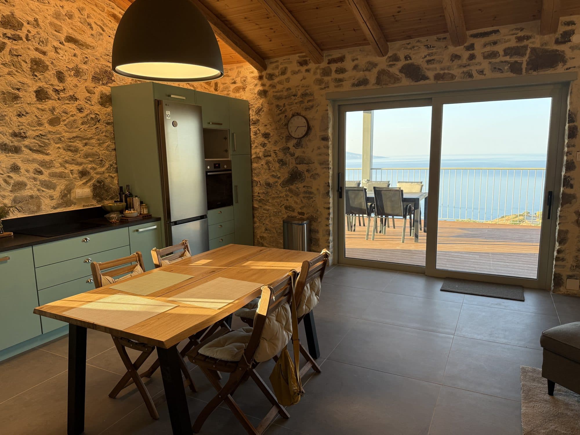 Open kitchen and dining opening to the sea-view terrace