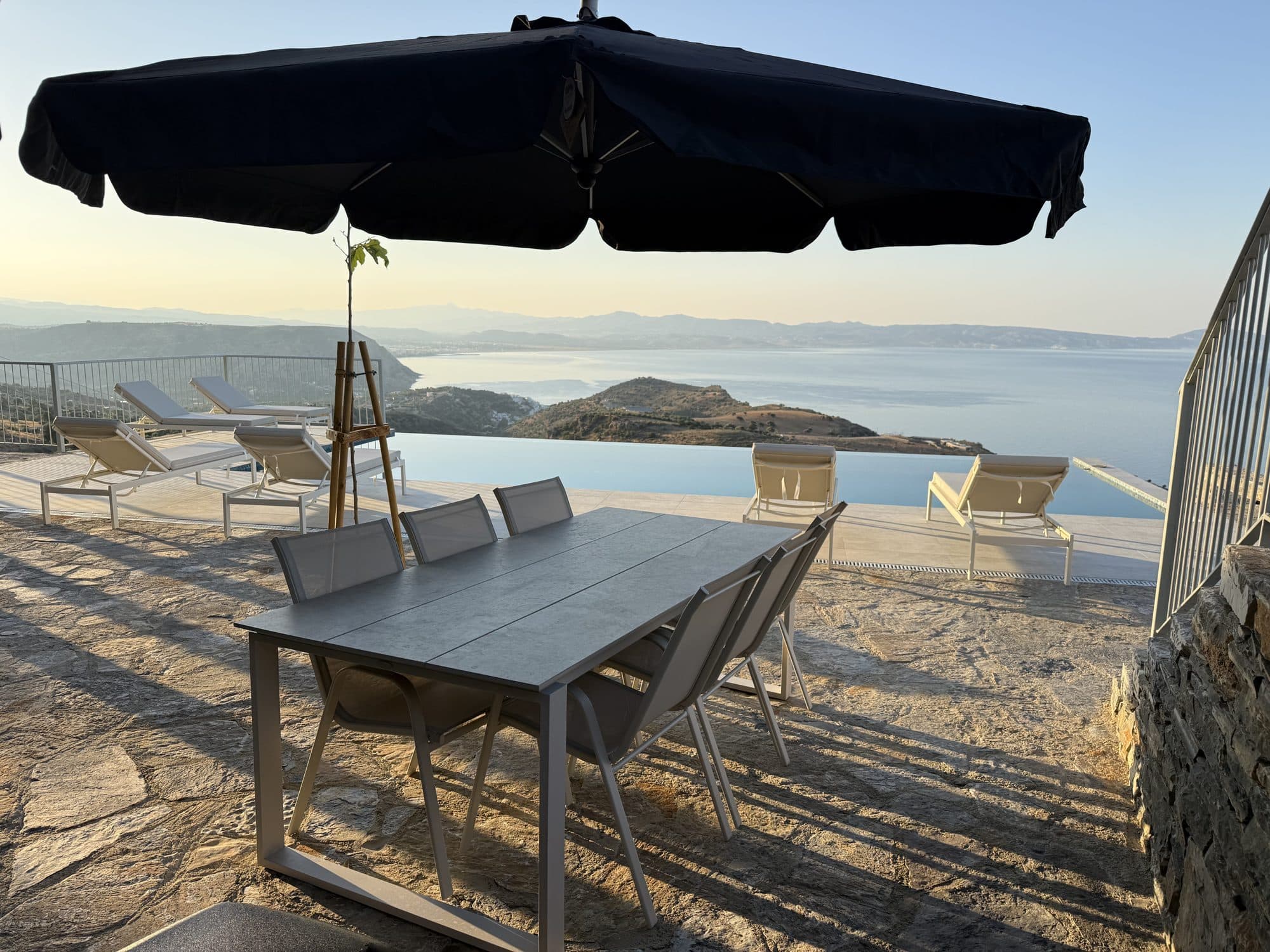 The infinity pool and Libyan Sea coastline at golden hour