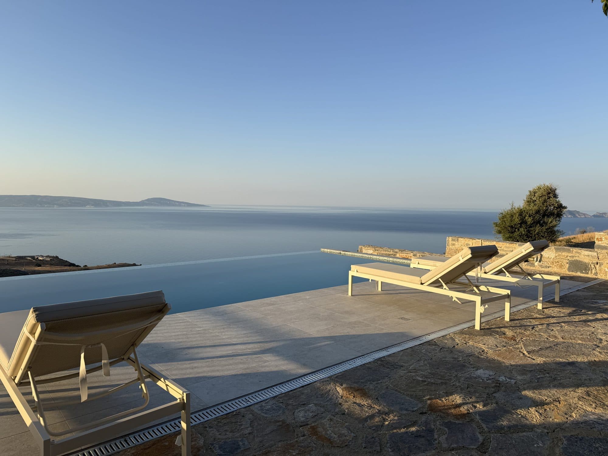 Sunbeds beside the infinity pool with the Libyan Sea beyond at first light
