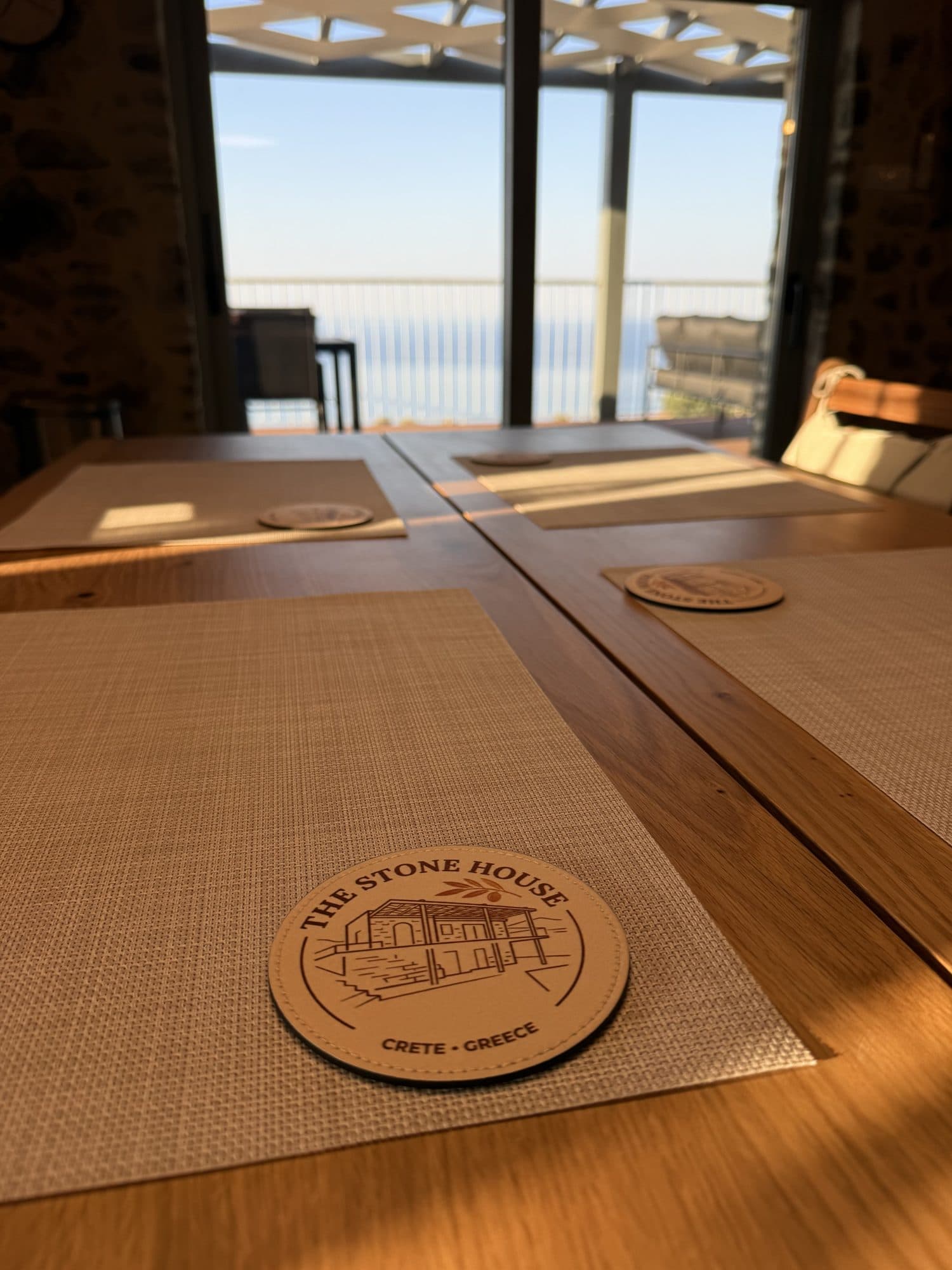 A place set at the oak table, the sea through the window